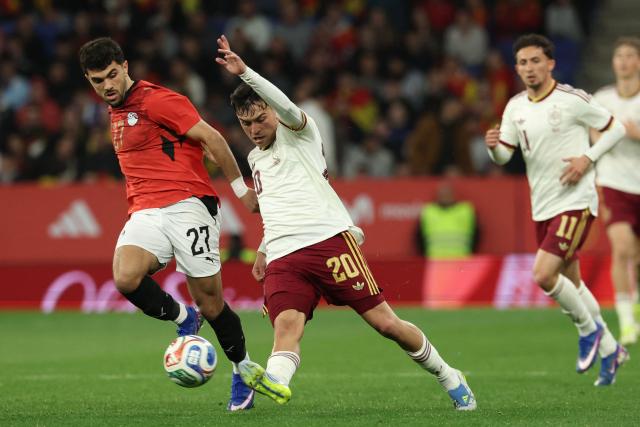 Spain's midfielder #20 Pedri vies for the ball with Egypt's midfielder #27 Mahmoud Saber (L) during the international friendly football match between Spain and Egypt at RCDE Stadium in Cornella de Llobregat, near Barcelona, on March 31, 2026. (Photo by Lluis GENE / AFP)