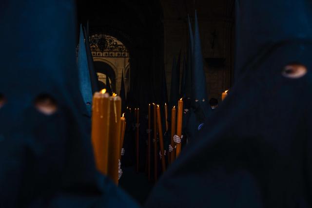 Penitents of the 'Los Estudiantes' brotherhood take part in a procession during Holy Week in Seville, Spain, on March 31 2026. Spain's colourful Holy Week celebrations started this week, featuring centuries-old processions of the faithful carrying flower-covered floats topped with statues of Christ or the Virgin Mary that draw huge crowds. Organised by various religious brotherhoods, or "confradias", the parades are held across the country in the week leading up to Easter Sunday, which this year in the Roman Catholic Church falls on April 5, 2026. (Photo by Cristina Quicler / AFP)