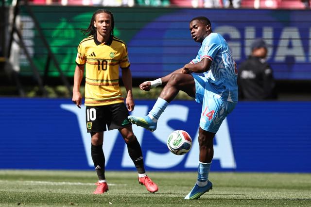 DR Congo's midfielder #14 Noah Sadiki kicks the ball past Jamaica's forward #10 Bobby Reid during the 2026 FIFA World Cup qualifiers final playoff football match between the Democratic Republic of the Congo and Jamaica at the Akron Stadium in Zapopan, Jalisco state, Mexico, on March 31, 2026. (Photo by Ulises Ruiz / AFP)