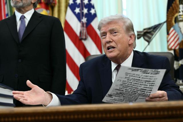 US President Donald Trump speaks to the press after signing an executive order in the Oval Office of the White House in Washington, DC, on March 31, 2026. (Photo by Brendan SMIALOWSKI / AFP)