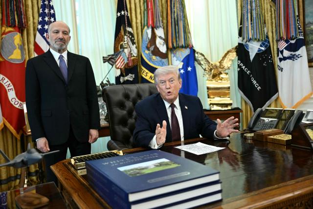 US President Donald Trump speaks as Commerce Secretary Howard Lutnick (L) looks on after he signed an executive order in the Oval Office of the White House in Washington, DC, on March 31, 2026. (Photo by Brendan SMIALOWSKI / AFP)