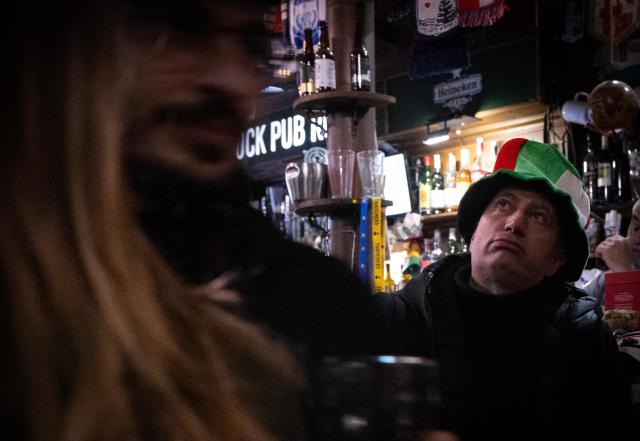 Italy fans react while watching the FIFA World Cup 2026 European qualification final football match between Bosnia-Herzegovina and Italy on a screen in a pub in central Rome on March 31, 2026. (Photo by TIZIANA FABI / AFP)