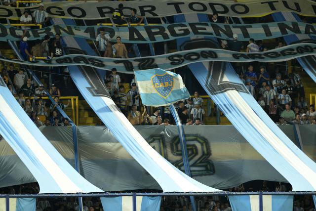 An Argentine fan waves a national flag with the Boca Juniors logo ahead of a friendly football match between Argentina and Zambia at La Bombonera stadium in Buenos Aires on March 31, 2026. (Photo by JUAN MABROMATA / AFP)