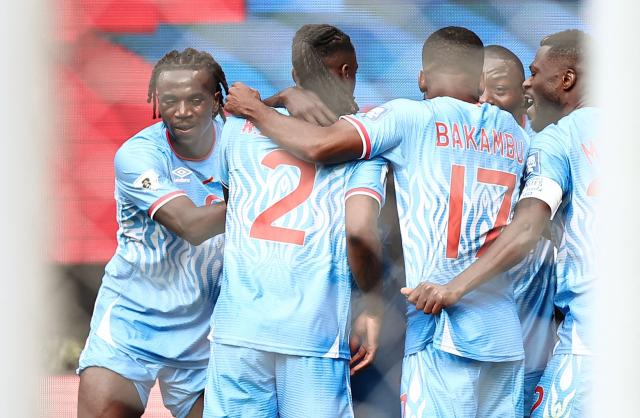 DR Congo's defender #04 Axel Tuanzebe (unseen) celebrates with teammates after scoring a goal in extra time during the 2026 FIFA World Cup qualifiers final playoff football match between the Democratic Republic of the Congo and Jamaica at the Akron Stadium in Zapopan, Jalisco state, Mexico, on March 31, 2026. (Photo by Ulises Ruiz / AFP)