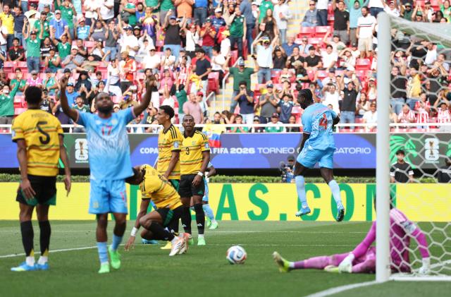 DR Congo's defender #04 Axel Tuanzebe (R) celebrates after scoring a goal in extra time during the 2026 FIFA World Cup qualifiers final playoff football match between the Democratic Republic of the Congo and Jamaica at the Akron Stadium in Zapopan, Jalisco state, Mexico, on March 31, 2026. (Photo by Ulises Ruiz / AFP)