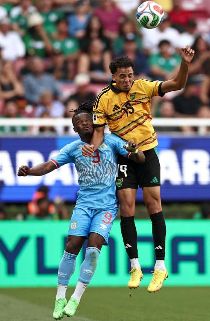DR Congo's midfielder #09 Brian Cipenga and Jamaica's defender #19 Ian Fray jump to head the ball during the 2026 FIFA World Cup qualifiers final playoff football match between the Democratic Republic of the Congo and Jamaica at the Akron Stadium in Zapopan, Jalisco state, Mexico, on March 31, 2026. (Photo by Ulises Ruiz / AFP)