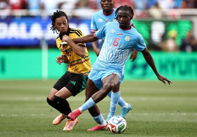 Jamaica's forward #21 Tyrese Hall and DR Congo's midfielder #06 Ngalayel Mukau fight for the ball during the 2026 FIFA World Cup qualifiers final playoff football match between the Democratic Republic of the Congo and Jamaica at the Akron Stadium in Zapopan, Jalisco state, Mexico, on March 31, 2026. (Photo by Ulises Ruiz / AFP)
