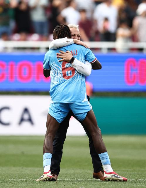 DR Congo's midfielder #06 Ngalayel Mukau and French head coach Sebastien Desabre celebrate after winning the match and qualifying for the World Cup during the 2026 FIFA World Cup qualifiers final playoff football match between the Democratic Republic of the Congo and Jamaica at the Akron Stadium in Zapopan, Jalisco state, Mexico, on March 31, 2026. (Photo by Ulises Ruiz / AFP)