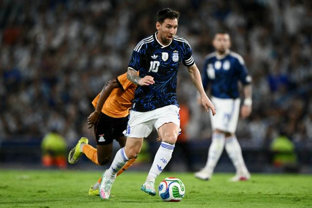 Argentina's forward #10 Lionel Messi runs with the ball during a friendly football match between Argentina and Zambia at La Bombonera stadium in Buenos Aires on March 31, 2026. (Photo by Luis ROBAYO / AFP)