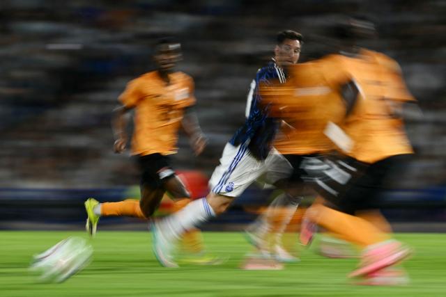 This slow shutter photograph shows Argentina's forward #10 Lionel Messi running during a friendly football match between Argentina and Zambia at La Bombonera stadium in Buenos Aires on March 31, 2026. (Photo by Luis ROBAYO / AFP)
