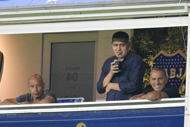 Boca Juniors' president Juan Roman Riquelme (C), former footballers Clemente Rodriguez (L) and Raul Cascini (R) watch a friendly football match between Argentina and Zambia at La Bombonera stadium in Buenos Aires on March 31, 2026. (Photo by JUAN MABROMATA / AFP)