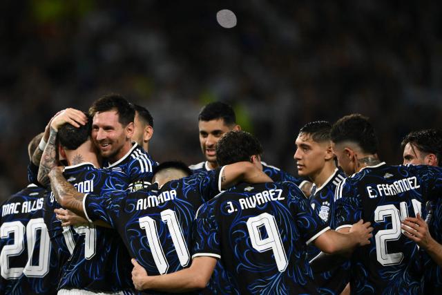 Argentina's defender #19 Nicolas Otamendi celebrates with teammates after scoring his team's third goal during a friendly football match between Argentina and Zambia at La Bombonera stadium in Buenos Aires on March 31, 2026. (Photo by Luis ROBAYO / AFP)
