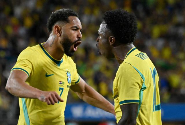 Brazil's forward #07 Matheus Cunha and Brazil's forward #10 Vinicius Junior celebrate their team's first goal during a friendly football match between Brazil and Croatia at Camping World Stadium in Orlando, Florida, on March 31, 2026. (Photo by MIGUEL J RODRIGUEZ CARRILLO / AFP)