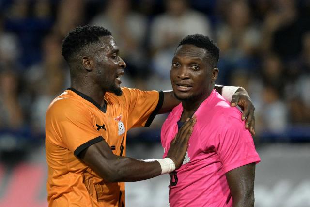 Zambia's defender #05 Tinkler Sinkala (L) congratulates his goalkeeper #16 Willard Mwanza after a save during a friendly football match between Argentina and Zambia at La Bombonera stadium in Buenos Aires on March 31, 2026. (Photo by JUAN MABROMATA / AFP)