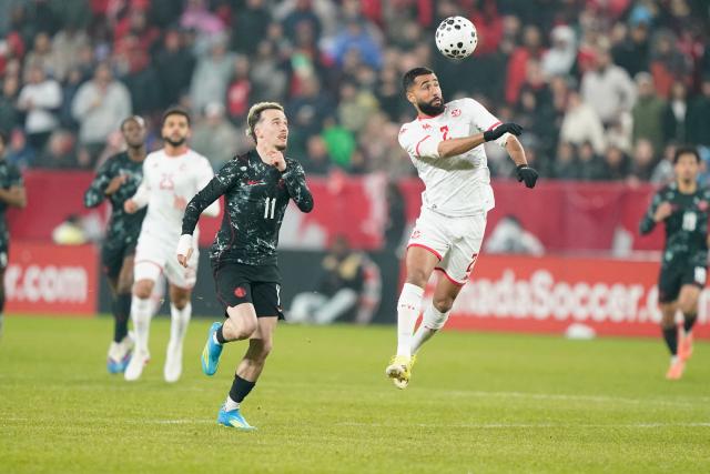 Tunisia's defender #02 Ali Abdi heads the ball while Canada's forward #11 Liam Millar looks on during a friendly between Canada and Tunisia at BMO Field in Toronto, Ontario,  on March 31, 2026. (Photo by Geoff Robins / AFP)