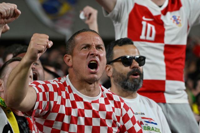 A Croatia's fan celebrates the goal of Croatia's midfielder #07 Lovro Majer (out of frame) during a friendly football match between Brazil and Croatia at Camping World Stadium in Orlando, Florida, on March 31, 2026. (Photo by MIGUEL J RODRIGUEZ CARRILLO / AFP)