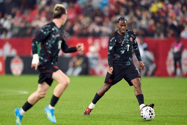 Canada's forward #07 Jonathan David (R) controls the ball during a friendly football match between Canada and Tunisia at BMO Field in Toronto, Canada, on March 31, 2026. (Photo by Geoff Robins / AFP)