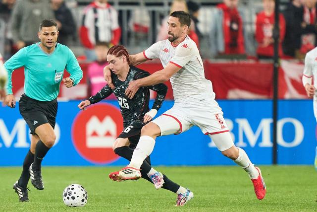 Tunisia's defender #05 Adem Arous (R) and Canada's midfielder #26 Marcelo Flores fight for the ball during a friendly football match between Canada and Tunisia at BMO Field in Toronto, Canada, on March 31, 2026. (Photo by Geoff Robins / AFP)
