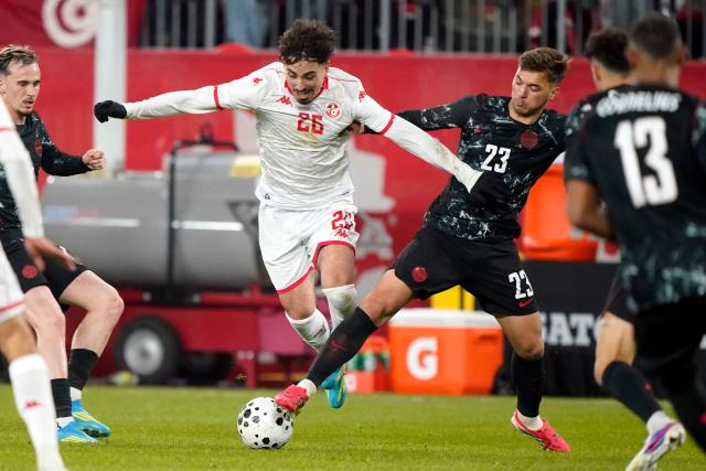 Tunisia's forward #26 Sebastian Tounekti and Canada's midfielder #23 Niko Sigur fight for the ball during a friendly football match between Canada and Tunisia at BMO Field in Toronto, Canada, on March 31, 2026. (Photo by Geoff Robins / AFP)
