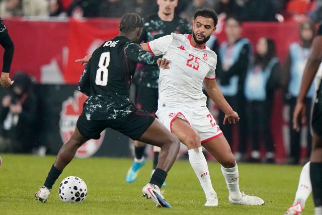 Tunisia's midfielder #25 Anis Ben Slimane and Canada's midfielder #08 Ismael Kone fight for the ball during a friendly football match between Canada and Tunisia at BMO Field in Toronto, Canada, on March 31, 2026. (Photo by Geoff Robins / AFP)
