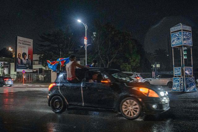 Congolese supporters celebrate in the streets following their team's victory in 2026 FIFA World Cup qualifiers final playoff football match between the Democratic Republic of the Congo and Jamaica, in Kinshasa early on April 1, 2026. The Democratic Republic of Congo defeated Jamaica 1-0 after extra time in an intercontinental playoff on March 31 to seal their first World Cup appearance in 52 years. (Photo by Glody MURHABAZI / AFP)
