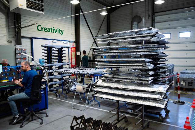 Employees work at the Survey Copter factory, an Airbus subsidiary, in Pierrelatte, southern France on March 31, 2026. At Survey Copter, a French SME integrated into Airbus, the European aerospace corporation is leaning on its know-how in helicopters to develop drones — which have become the sinews of modern warfare — and to make them cooperate with manned aircraft. (Photo by OLIVIER CHASSIGNOLE / AFP)