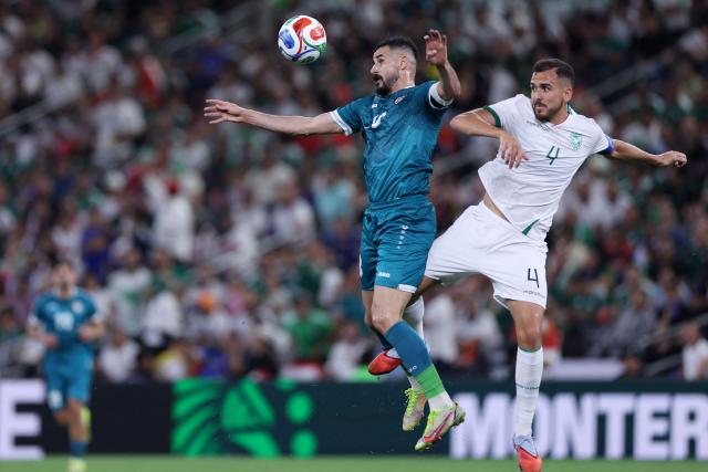 Iraq's forward #18 Aymen Hussein and Bolivia's defender #04 Luis Haquin fight for the ball during the 2026 FIFA World Cup qualifiers final playoff football match between Iraq and Bolivia at the BBVA Stadium in Guadalupe, Nuevo Leon state, Mexico, on March 31, 2026. (Photo by Julio Cesar AGUILAR / AFP)