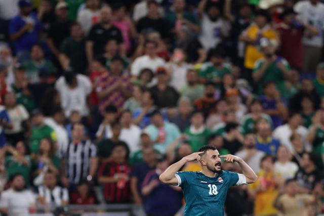 TOPSHOT - Iraq's forward #18 Aymen Hussein celebrates scoring his team's second goal during the 2026 FIFA World Cup qualifiers final playoff football match between Iraq and Bolivia at the BBVA Stadium in Guadalupe, Nuevo Leon state, Mexico, on March 31, 2026. (Photo by Julio Cesar AGUILAR / AFP)