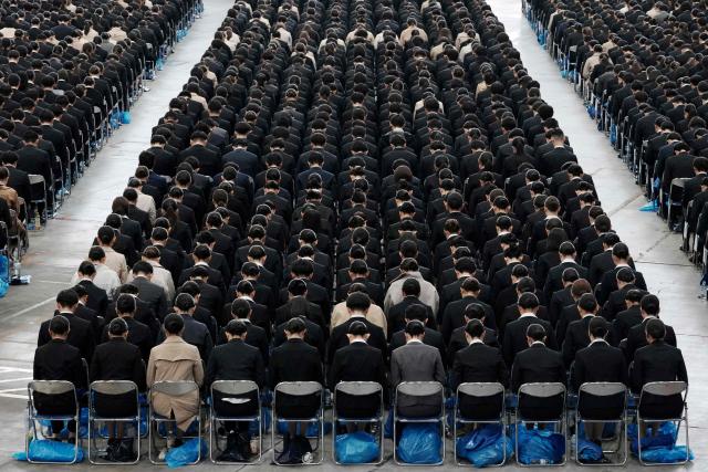 New employees of All Nippon Airways (ANA) Group attend an annual entrance ceremony at an aircraft hangar of Tokyo's Haneda Airport on April 1, 2026, the first day of the new fiscal year. (Photo by Kazuhiro NOGI / AFP)