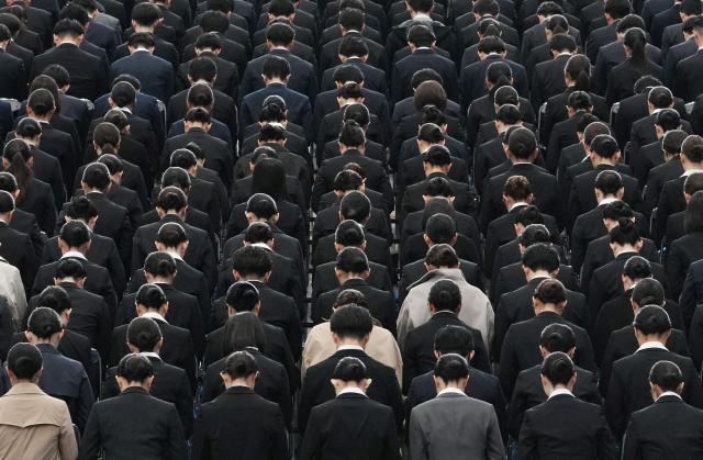 New employees of All Nippon Airways (ANA) Group attend an annual entrance ceremony at an aircraft hangar of Tokyo's Haneda Airport on April 1, 2026, the first day of the new fiscal year. (Photo by Kazuhiro NOGI / AFP)