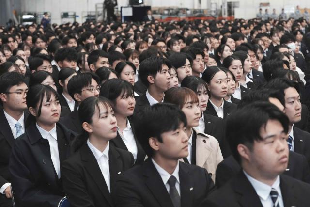 New employees of All Nippon Airways (ANA) Group attend an annual entrance ceremony at an aircraft hangar of Tokyo's Haneda Airport on April 1, 2026, the first day of the new fiscal year. (Photo by Kazuhiro NOGI / AFP)