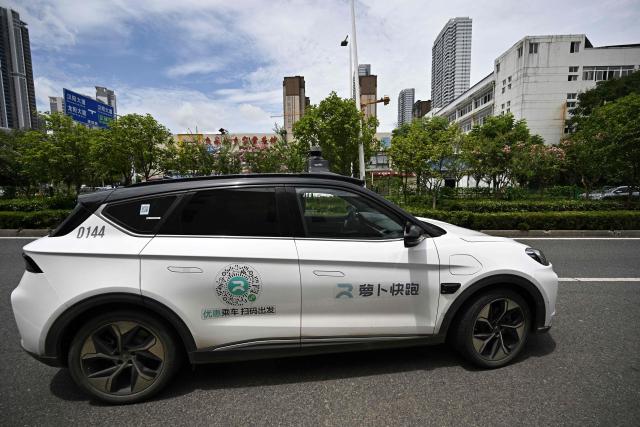 This file photo taken on August 1, 2024 shows a general view of a driverless robotaxi autonomous vehicle developed as part of tech giant Baidu's Apollo Go self-driving project, in Wuhan, in central China's Hubei province. A string of self-driving robotaxis owned by Chinese internet giant Baidu stalled in central China, stranding passengers after an apparent "system malfunction", police said on April 1,2026. (Photo by PEDRO PARDO / AFP)