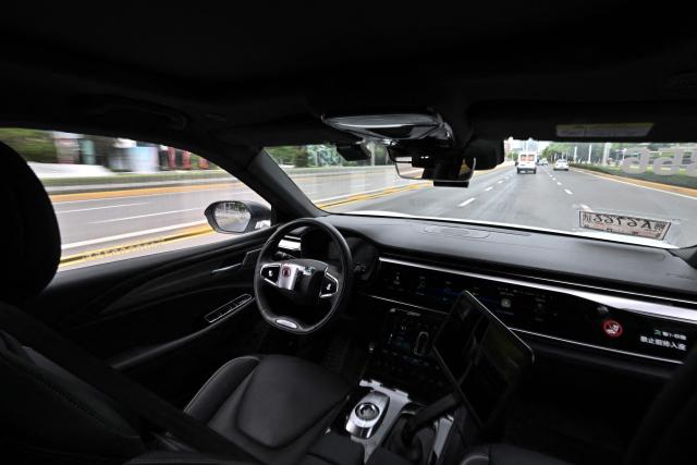 This file photo taken on August 1, 2024 shows a general view of the driver's seat and controls of a driverless robotaxi autonomous vehicle developed as part of tech giant Baidu's Apollo Go self-driving project, in Wuhan, in central China's Hubei province. A string of self-driving robotaxis owned by Chinese internet giant Baidu stalled in central China, stranding passengers after an apparent "system malfunction", police said on April 1,2026. (Photo by PEDRO PARDO / AFP)