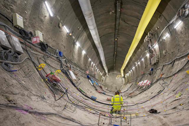 (FILES) An engineer installs measuring sensors before covering the gallery surface, at a depth of 490 meters in the Meuse/Haute Marne Underground Research Laboratory of the nuclear waste burial site known as Cigeo (Centre Industriel de stockage Geologique - Industrial Centre for Geological Disposal), operated by the French National agency for the management of radioactive waste, Andra, in Bure, eastern France, on August 8, 2024. The cost of Cigeo, a project to bury the most radioactive nuclear waste in Bure (Meuse), has been estimated by the state at 33.36 billion euros, up from the 25 billion envisaged in 2016, according to a decree published on April 1, 2026 in the Journal officiel. This updated total cost, based on January 2025 economic conditions, falls within the range estimated in May 2025 by the National Agency for Radioactive Waste Management (Andra), the project's developer, which stood between 26.1 and 37.5 billion euros. (Photo by Jean-Christophe VERHAEGEN / AFP)