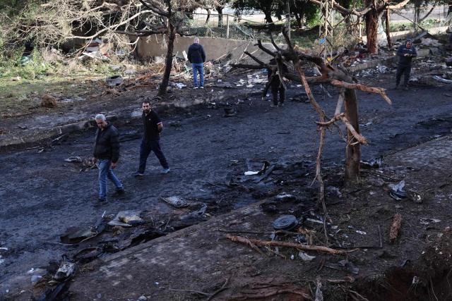 People assess the damage at the site of an Israeli strike in Beirut on April 1, 2026. Lebanon was drawn into the Middle East war on March 2 when Tehran-backed militant group Hezbollah launched attacks on Israel to avenge the killing of the Iranian leader. Israel has responded with broad strikes across Lebanon and a ground offensive. (Photo by Anwar AMRO / AFP)