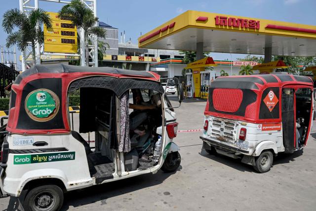 Tuk tuk vehicles queue up to refuel with liquefied petroleum gas (LPG) at a fuel station in Phnom Penh on April 1, 2026. Cambodia's diesel price on April 1 reached double its level at the start of the Middle East war after the latest government increase, official figures showed, raising concerns among farmers ahead of ploughing season. (Photo by TANG CHHIN Sothy / AFP)