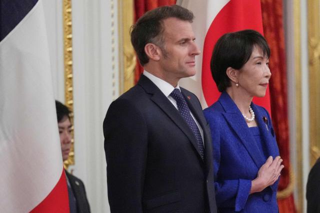 Japan’s Prime Minister Sanae Takaichi (R) and French President Emmanuel Macron attend a welcome ceremony at the Akasaka Palace State Guest House in Tokyo on April 1, 2026. (Photo by Hiro Komae / POOL / AFP)