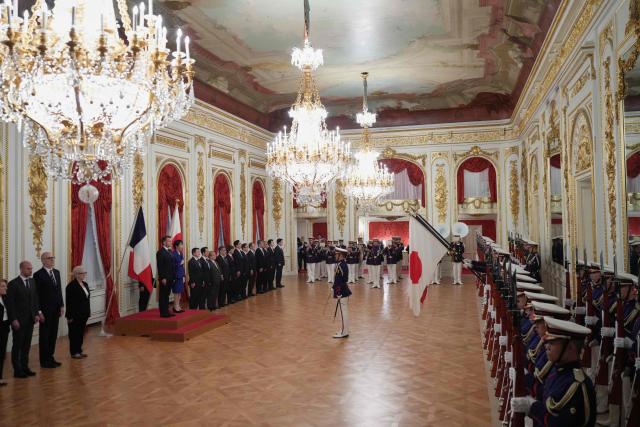 Japan’s Prime Minister Sanae Takaichi (center-L) and French President Emmanuel Macron attend a welcome ceremony at the Akasaka Palace State Guest House in Tokyo on April 1, 2026. (Photo by Hiro Komae / POOL / AFP)