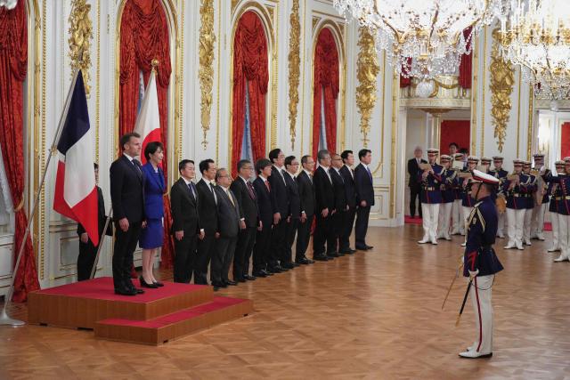 Japan’s Prime Minister Sanae Takaichi (2nd-L) and French President Emmanuel Macron (L) attend a welcome ceremony at the Akasaka Palace State Guest House in Tokyo on April 1, 2026. (Photo by Hiro Komae / POOL / AFP)