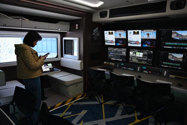 An employee works in a digital entertainment production vehicle during a tour at the Alibaba office in Beijing on April 1, 2026. (Photo by WANG Zhao / AFP)