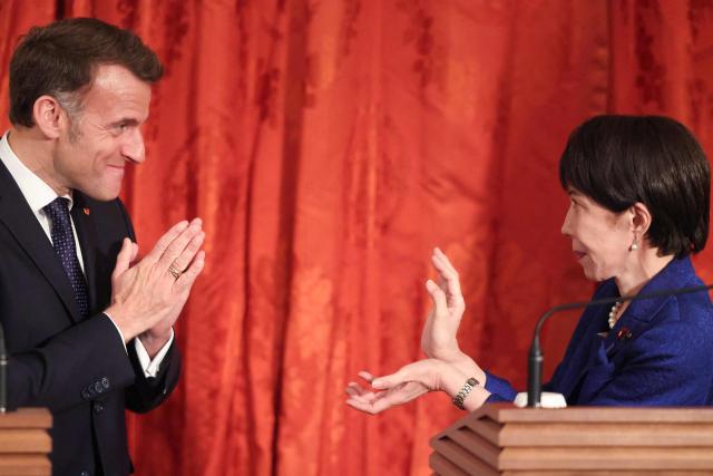 Japan's Prime Minister Sanae Takaichi (R) and French President Emmanuel Macron react during a press conference at Akasaka Palace in Tokyo on April 1, 2026. (Photo by Ludovic MARIN / AFP)