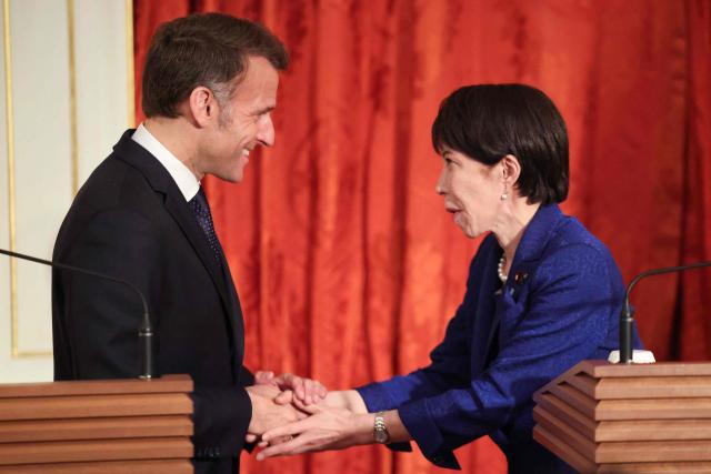 Japan's Prime Minister Sanae Takaichi (R) and French President Emmanuel Macron shake hands during a press conference at Akasaka Palace in Tokyo on April 1, 2026. (Photo by Ludovic MARIN / AFP)