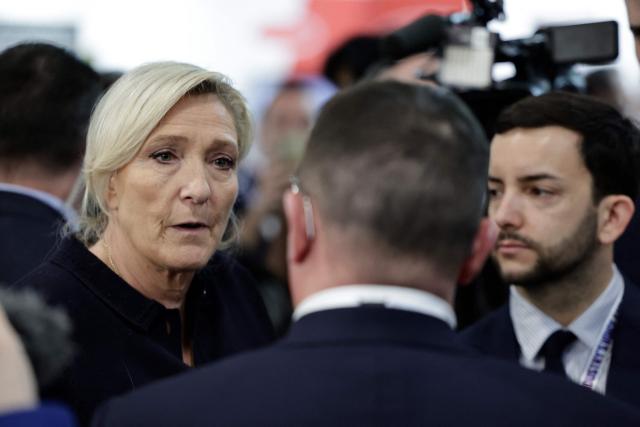 Far-right Rassemblement National (RN) parliamentary group president Marine Le Pen (L) and Rassemblement National's MP Jean-Philippe Tanguy (R) visit the Global Industrie trade show at the Paris Nord Villepinte exhibition centre in Villepinte, northeast of Paris, on April 1, 2026. (Photo by STEPHANE DE SAKUTIN / AFP)