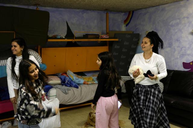 Adva (L) and Olga (R) speak with their children inside a shelter in the northern Israeli town of Kiryat Shmona near the border with Lebanon on March 30, 2026. Lives paced by sirens and confined within four walls. The city is empty, deserted by its young people. In Kiryat Shmona, on the frontline of the war between Israel and Lebanon's Hezbollah, those who have stayed can't take it anymore and feel "neglected" by the government. (Photo by Jalaa MAREY / AFP)