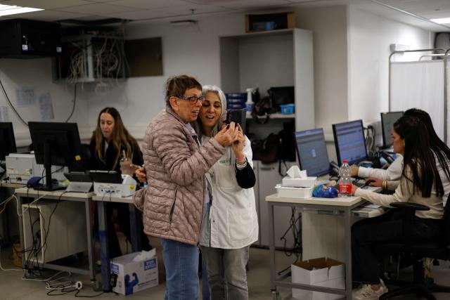 Medical staff have a video call at a clinic run by Clalit Health Services in the northern Israeli town of Kiryat Shmona near the border with Lebanon on March 30, 2026. Lives paced by sirens and confined within four walls. The city is empty, deserted by its young people. In Kiryat Shmona, on the frontline of the war between Israel and Lebanon's Hezbollah, those who have stayed can't take it anymore and feel "neglected" by the government. (Photo by Jalaa MAREY / AFP)