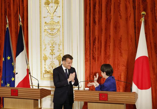Japan's Prime Minister Sanae Takaichi and French President Emmanuel Macron react during a press conference at Akasaka Palace in Tokyo on April 1, 2026. (Photo by Franck ROBICHON / POOL / AFP)