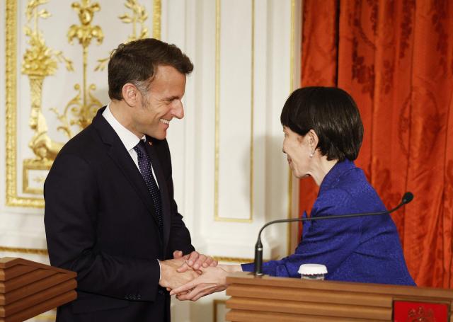 Japan's Prime Minister Sanae Takaichi and French President Emmanuel Macron shake hands during a press conference at Akasaka Palace in Tokyo on April 1, 2026. (Photo by Franck ROBICHON / POOL / AFP)