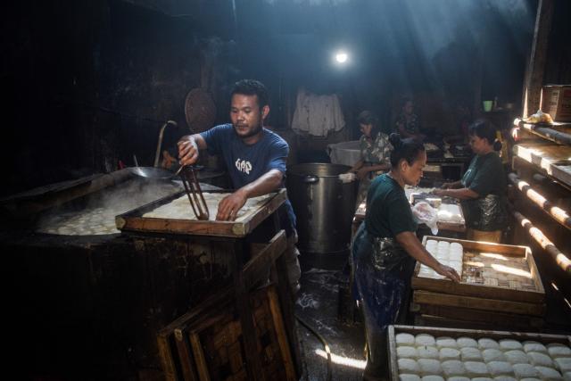 Workers make traditional tofu with soybean paste in Bandung, West Java, April 1, 2026. (Photo by Timur Matahari / AFP)