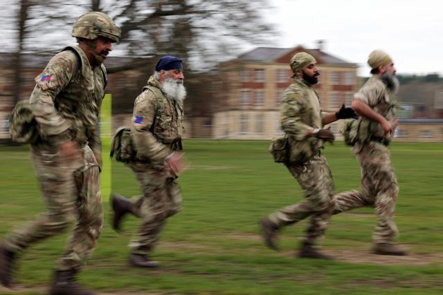 Soldiers from the Defence Sikh Network and British Army take part in Holla Mohalla, the annual Sikh military festival, celebrating Sikh martial traditions at the Royal Military Academy at Sandhurst on April 01, 2026. Participants took part in a soldier Role fitness test, traditional Sikh martial arts, traditional Sikh military games, and Rang colour powder throwing. The centuries old festival is held in the spirit of fierce but well natured competition and aims to promote courage, preparation, and readiness. Sikhs have been serving in the British Army since the 1800s. (Photo by Adrian Dennis / AFP)