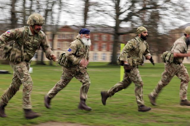 Soldiers from the Defence Sikh Network and British Army take part in Holla Mohalla, the annual Sikh military festival, celebrating Sikh martial traditions at the Royal Military Academy at Sandhurst on April 01, 2026. Participants took part in a soldier Role fitness test, traditional Sikh martial arts, traditional Sikh military games, and Rang colour powder throwing. The centuries old festival is held in the spirit of fierce but well natured competition and aims to promote courage, preparation, and readiness. Sikhs have been serving in the British Army since the 1800s. (Photo by Adrian Dennis / AFP)
